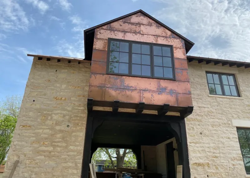 Copper metal panel facade on a stone building for Skylight Installation in Oceano